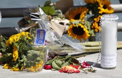 Flowers and a candle lay on the ground following a vigil for Kathryn Steinle on Monday in San Francisco