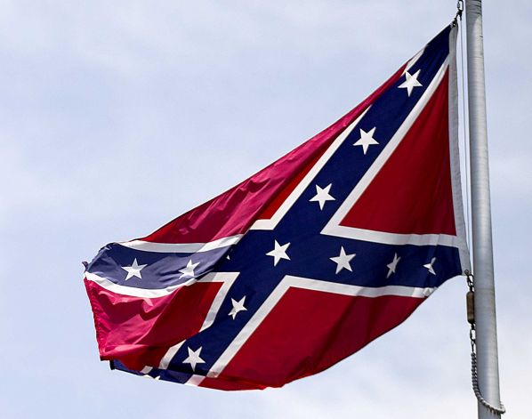 Confederate flag flies at the base of Stone Mountain in Stone Mountain Ga. The House is about to put its members on record on whether Confederate flags can decorate rebel graves in historic federal cemeteries