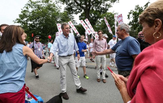 Republican presidential candidate former Florida Gov. Jeb Bush center shakes hands while participating in the Fourth of July Parade in Amherst N.H. Saturday