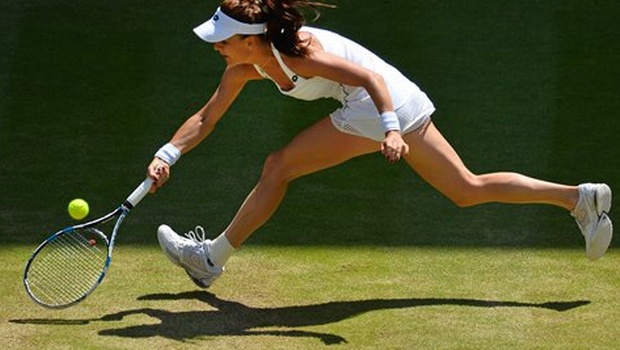 Agnieszka Radwanska of Poland makes a return to Garbine Muguruza of Spain during the women's singles semifinal match at the All England Lawn Tennis Championships in Wimbledon London. |AP