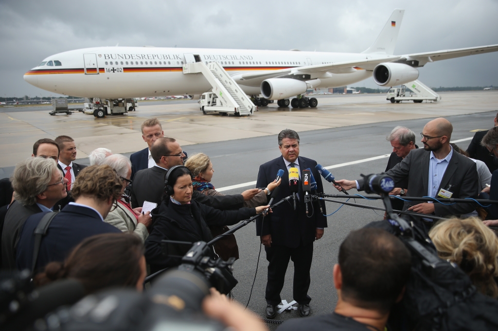 German Vice Chancellor and Economy and Energy Minister Sigmar Gabriel speaks to the media about the just-passed Greece aid package before boarding a German delegation flight to China