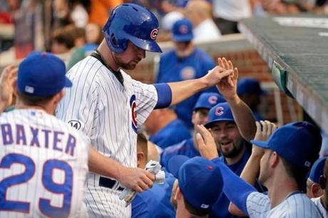 CHICAGO IL- JULY 06 Jon Lester #34 of the Chicago Cubs is congratulated after his first career hit in the Major League against the St. Louis Cardinals during the second inning at Wrigley Field