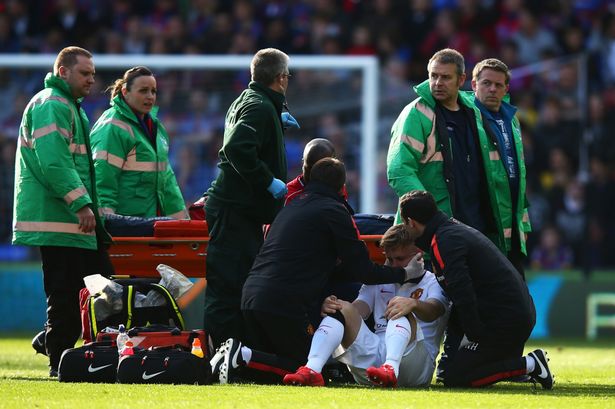 Luke Shaw receives treatment before leaving the field on a stretcher