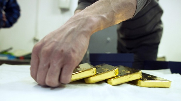 Gold fell to a five-year low pressured by a strong US dollar and expectations for a US interest rate rise this year