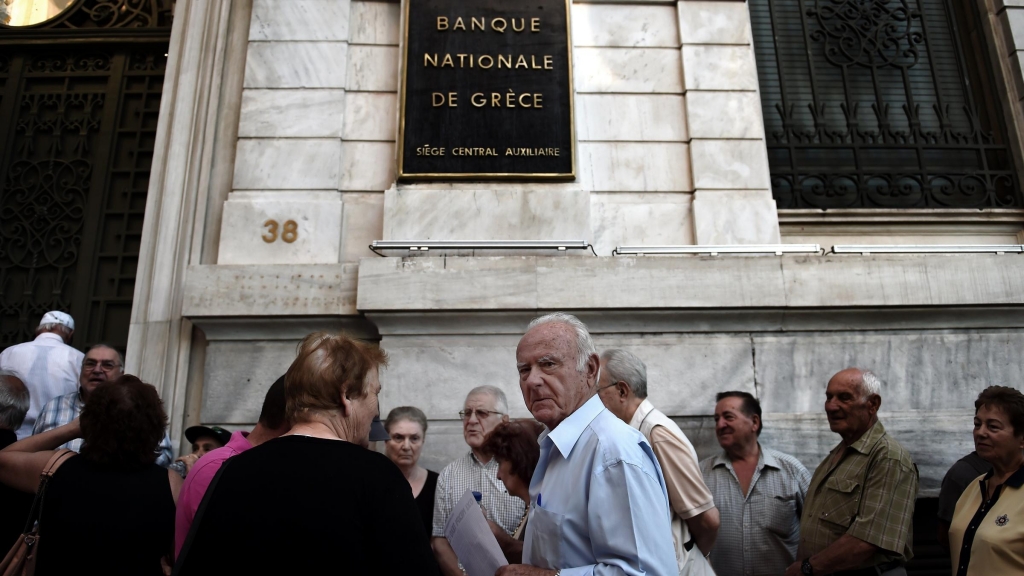 Pensioners queue outside a national bank branch in Athens on Thursday. Greek banks are running out of cash and the situation poses further danger to the economy analysts say