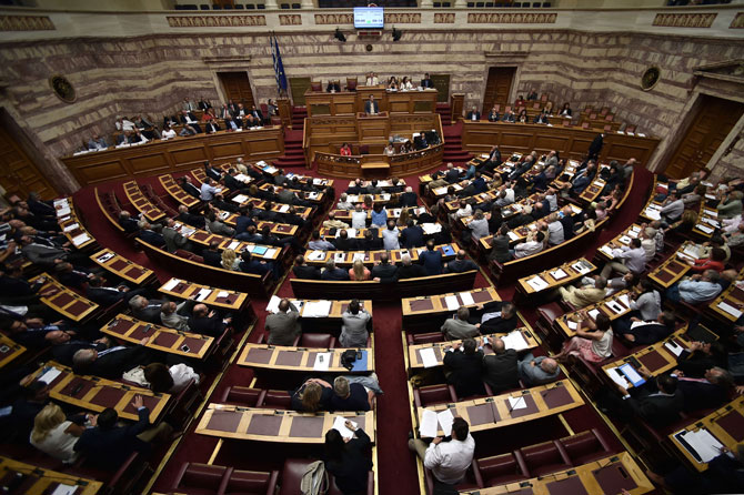 Greek lawmakers attend a parliament session in Athens