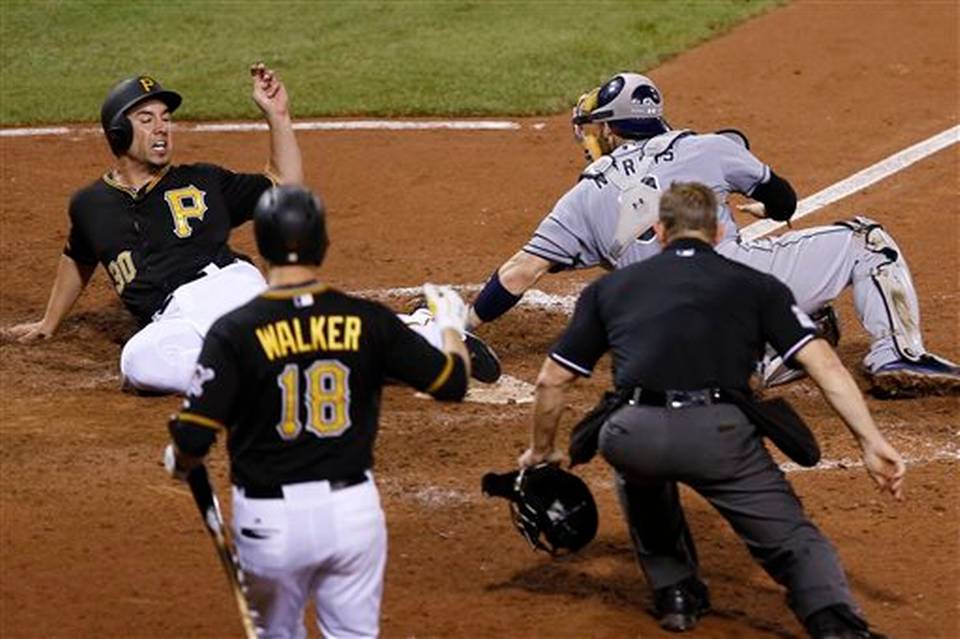 Pittsburgh Pirates&#39 Travis Ishikawa left scores on a hit by Gregory Polanco as San Diego Padres catcher Derek Norris reaches to tag him in the eighth inning of a baseball game Wednesday