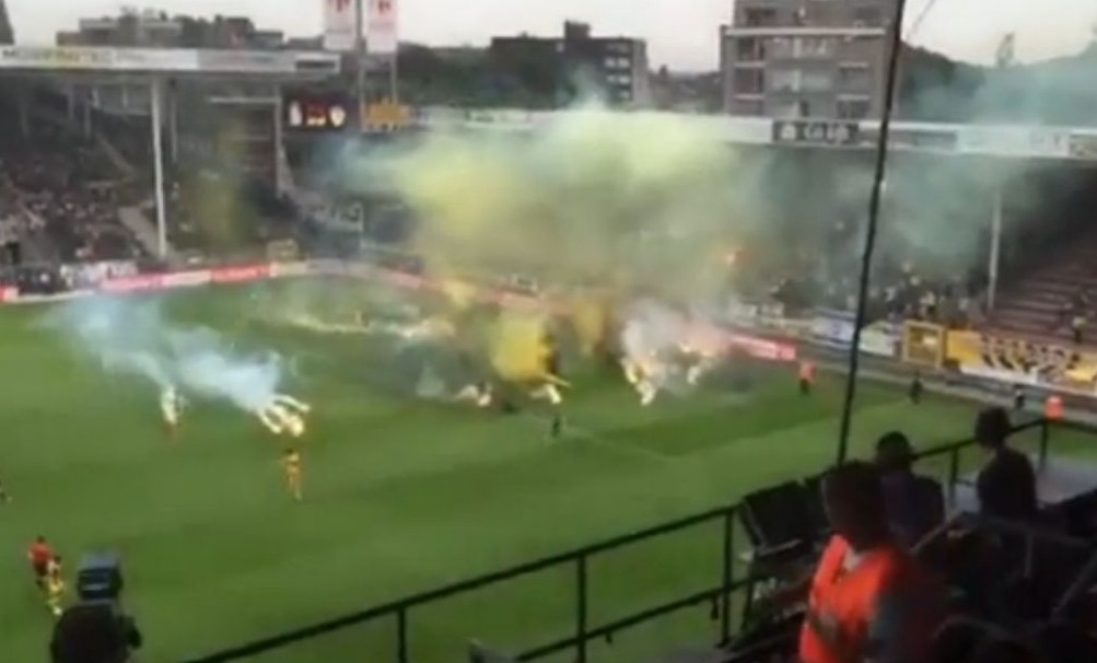 Smoke bombs and flares are thrown onto the pitch by fans of Beitar Jerusalem soccer club during an away match against Belgian team Sporting Charleroi on Thursday