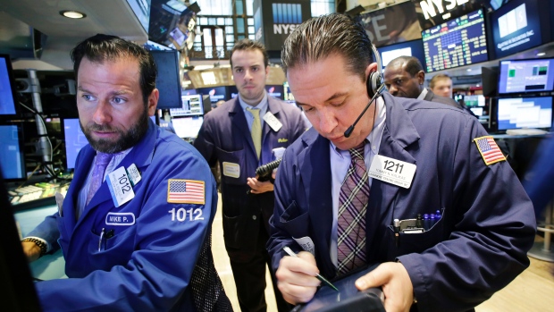 A television monitor carries news of the'No vote on the Greek debt referendum as a trader works on the floor of the New York Stock Exchange Monday