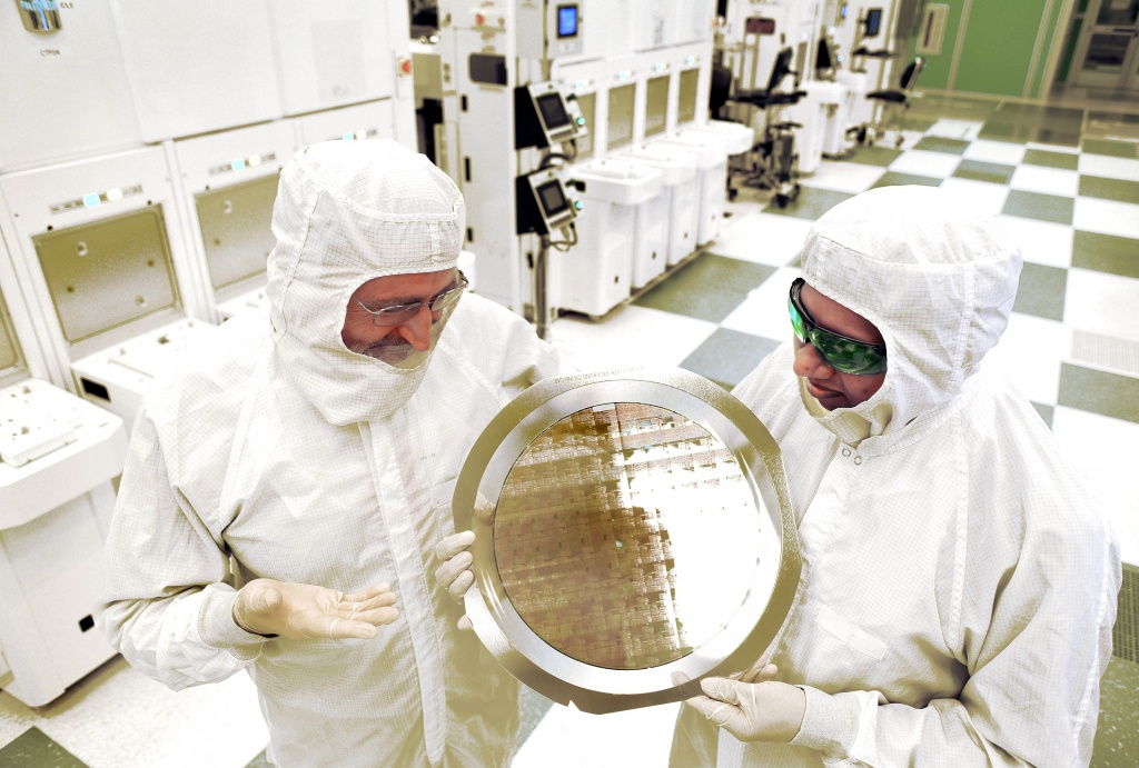 SUNY College of Nanoscale Science and Engineering's Michael Liehr left and IBM's Bala Haranand look at wafer comprised of 7nm chips on Thursday