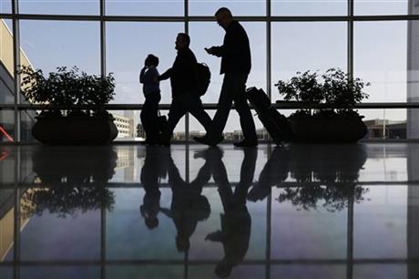 Travelers pass through a corridor at Philadelphia International Airport in Philadelphia