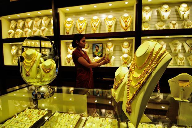 Gold prices slide to 5-year lows on strong dollar