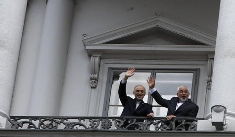 Iranian Foreign Minister Javad Zarif and Iranian Atomic Energy Organization Ali Akbar Salehi stand on the balcony of Palais Coburg the venue for nuclear talks in Vienna Austria