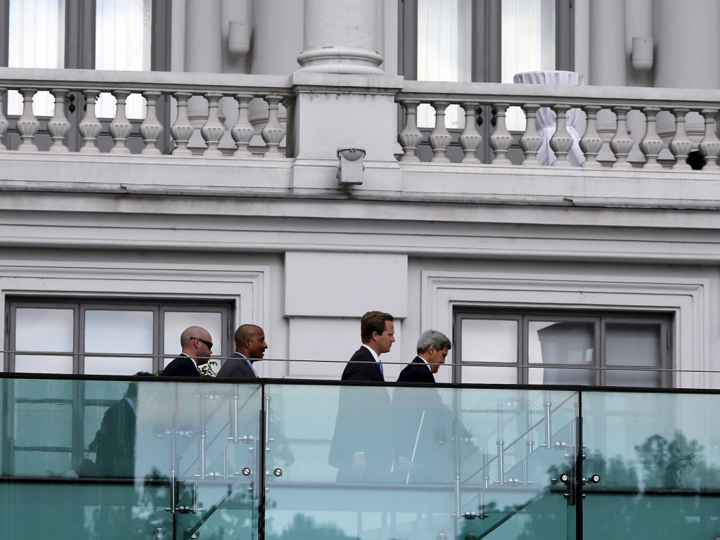 Secretary of State John Kerry walks using crutches at the garden of the hotel where the Iran nuclear talks meetings are being held in Vienna on Thursday