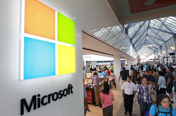 A new Microsoft Corp. logo left is seen on an exterior wall of a new Microsoft store inside the Prudential Center mall in Boston Thursday Aug. 23 2012. The introduction of the new logo marks the first time that Microsoft Corp has revamped its logo