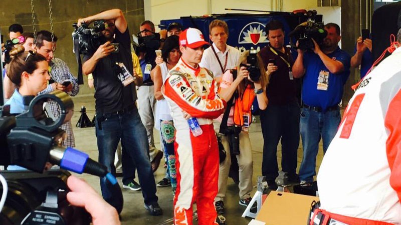 Jeff Gordon standing by while his crew works to get his car repaired enough to drive