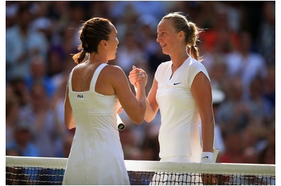 Jelena Jankovic shakes hands with Petra Kvitova after defeating the champion in three sets