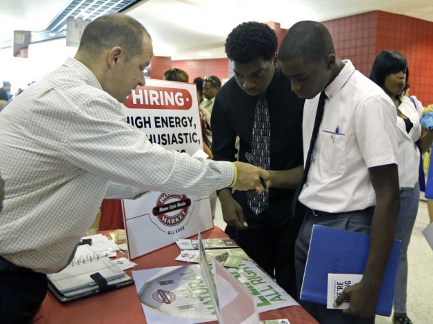 10 2015 Mario Polo of Boston Market left talks to job seekers Herby Joseph right and Kingsly Jose center at a job fair in Sunrise Fla. The Labor Department issues its May report on job openings and labor turno