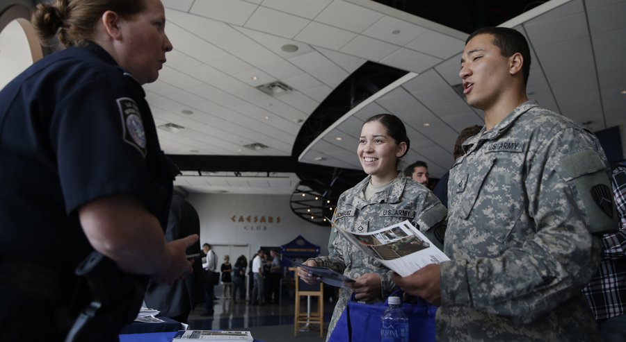 2015 Kerry P. Gorman left with the U.S. Dept. of Homeland Security speaks to Pfc. Melanie Rodriguez center of the Bronx and Pfc Anthony Sanelli of Queens about employment opportunities during a job fair at Citi Field