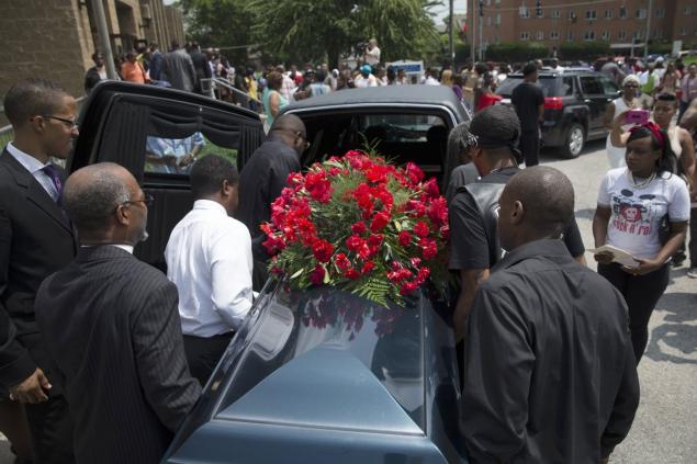 The casket of Samuel Dubose is transported to a hearse during his funeral on Tuesday