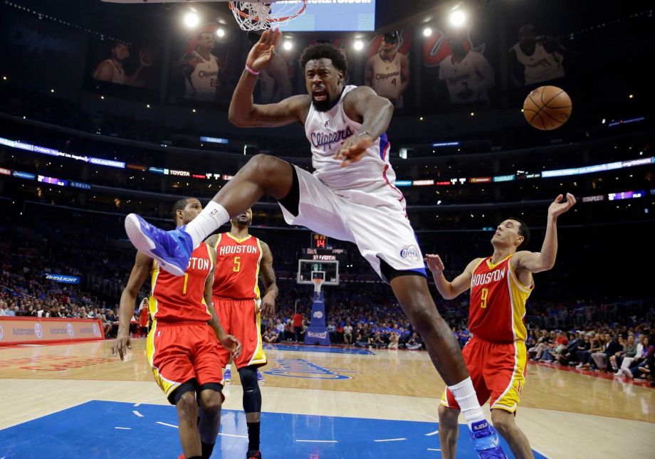 Los Angeles Clippers center De Andre Jordan second from right celebrates after dunking as Houston Rockets forward Trevor Ariza left Josh Smith second from left and guard Pablo Prigioni of Argentina watch dur