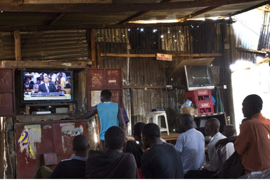 People watch U.S. President Barack Obama deliver a speech on television from the Kibera slum in Nairobi Kenya July 26. In the speech President Obama challenged the land of his father to end corruption overcome ethnic divisions and stop discrimination