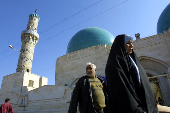 Locals walk along a Shia mosque