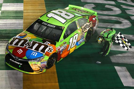 Kyle Busch salutes the crowd with his traditional post race bow after winning the Sprint Cup Series Quaker State 400 at Kentucky Speedway