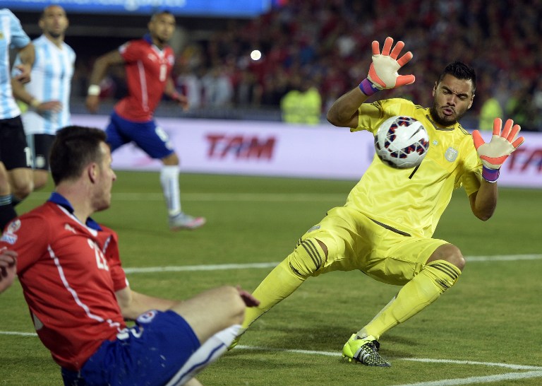 Argentina's goalkeeper Sergio Romero savesa a shot by Chile's forward Angelo Henriquez during their 2015 Copa America football championship final in Santiago Chile