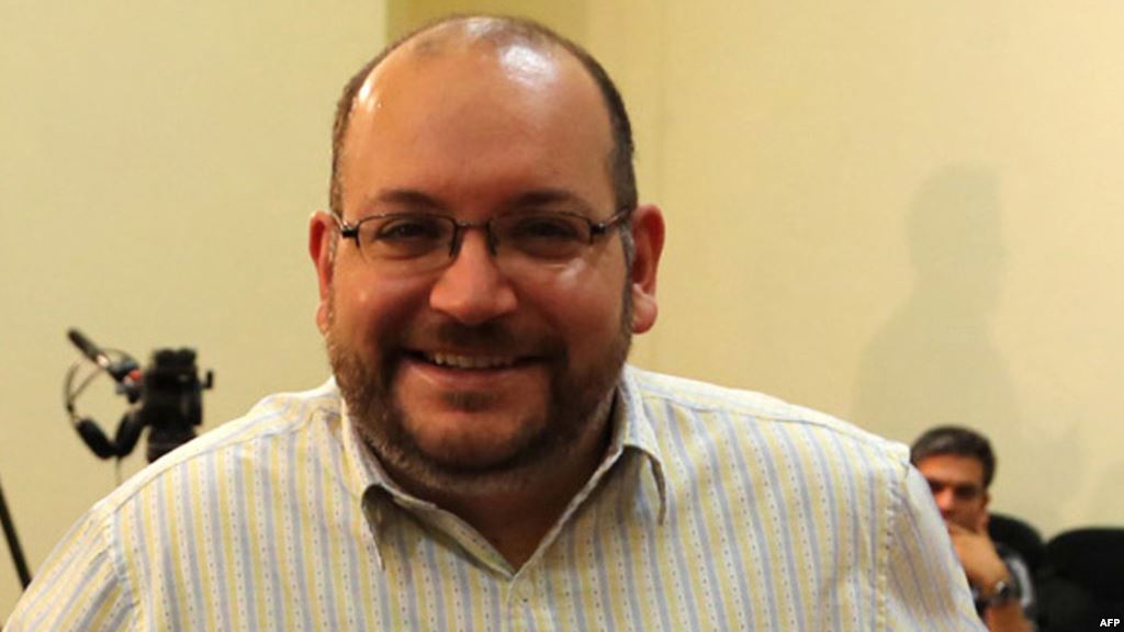 Iranian-American Washington Post correspondent Jason Rezaian poses while covering a press conference at Iran's Foreign Ministry in Tehran in September 2013