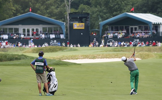 Scott Langley right takes his second shot to the 17th green during the final round of the Greenbrier Classic golf tournament at Greenbrier Resort in White Sulphur Springs