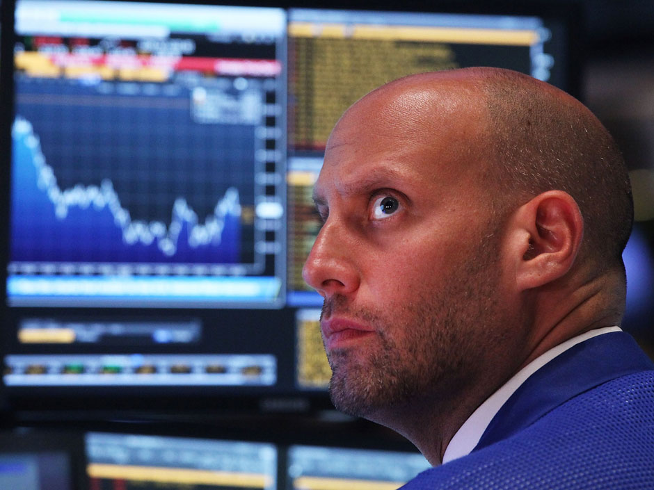 A trader works on the floor of the New York Stock Exchange. North American markets were mixed Thursday