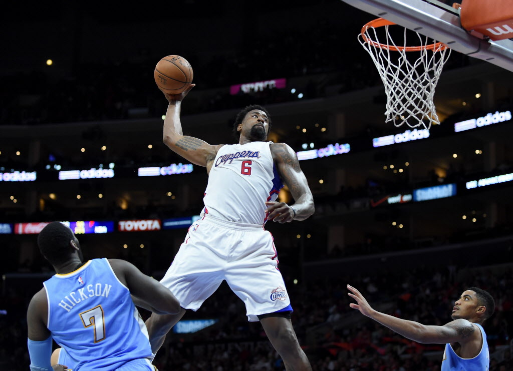 LOS ANGELES CA- APRIL 13 De Andre Jordan #6 of the Los Angeles Clippers attempts an alley-oop dunk between J.J. Hickson #7 and Gary Harris #14 of the Denver Nuggets during a 110-103 Clipper win at Staples Center