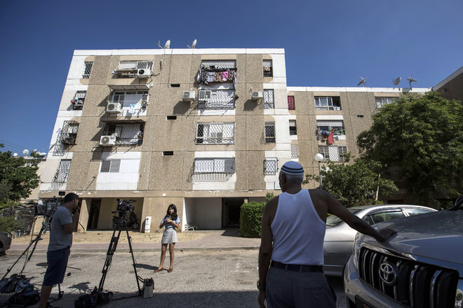 Israeli journalists report outside the apartment building of Ethiopian Israeli Avraham Mengisto 28 in the costal city of Ashkelon Israel Thursday