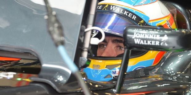 McLaren's Fernando Alonso waits in his car at the Austrian Grand Prix where the team were forced to start from the back of the grid