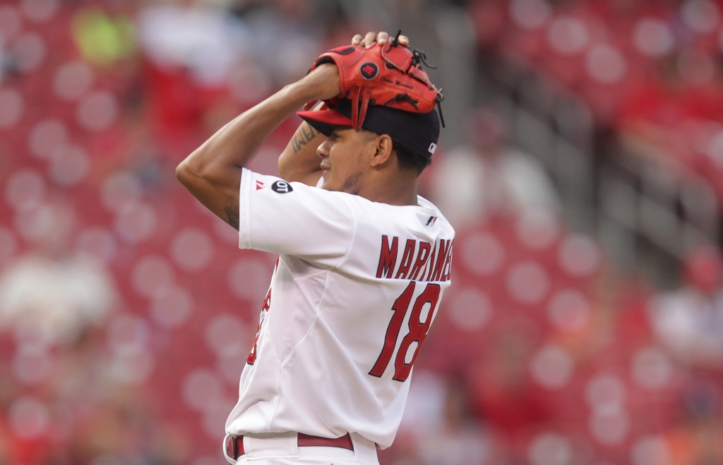 St. Louis Cardinals pitcher Carlos Martinez grabs his head after giving up a walk to New York Mets Jacob de Grom in the 17th inning at Busch Stadium in St. Louis