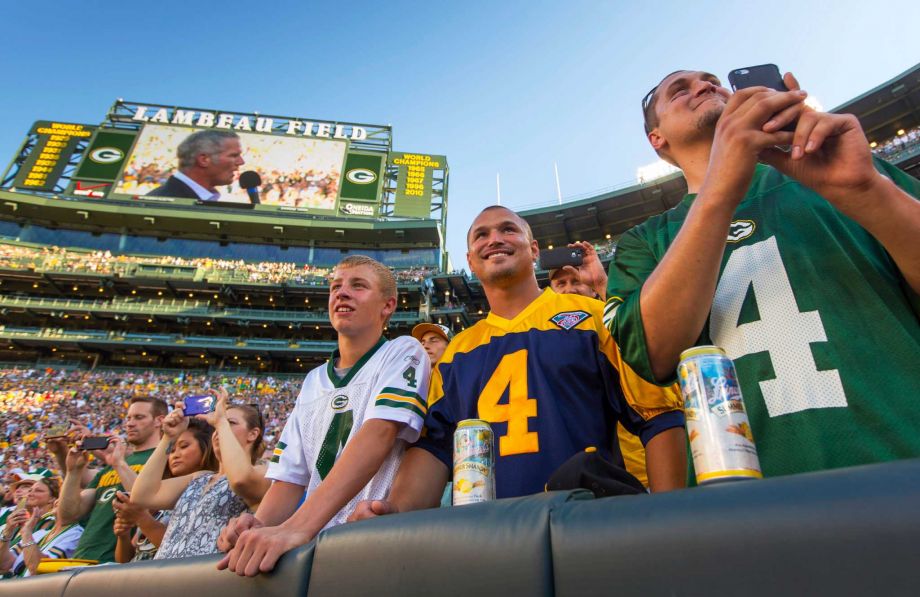 Fans watch former Green Bay Packers quarterback Brett Favre give a speech at Lambeau Field prior to his induction to the Packers Hall of Fame and having his No. 4 jersey retired Saturday