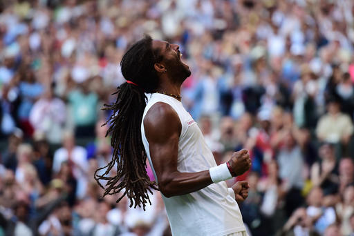 Dustin Brown of Germany celebrates victory over Rafael Nadal of Spain during day four of the Wimbledon Lawn Tennis Championships