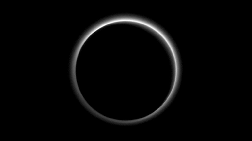 Backlit by the sun Pluto’s atmosphere rings its silhouette like a luminous halo in this image taken by NASA’s New Horizons spacecraft around midnight EDT on July 15. This global portrait of the atmosphere was captured when the spacecraft was about 1