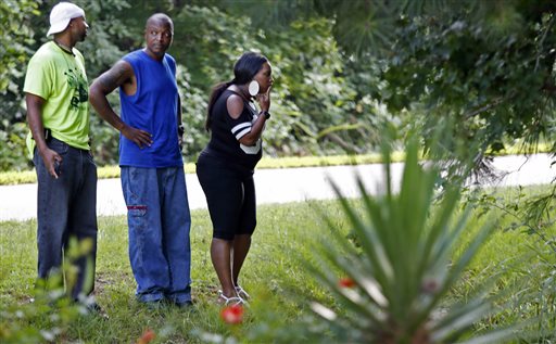 From left Johnston county residents Tamaki May Tyrone Harris and May's wife Lakia May take a closer look at the crash site at the corner of Simon Road and Buckhorn Drive just south of Middlesex NC in Johnston county Monday