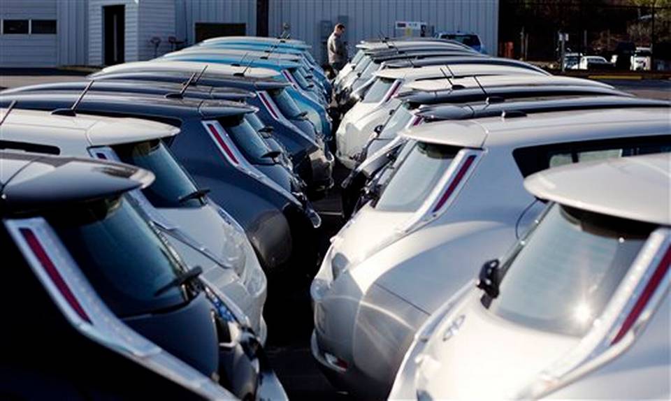 Nissan electric vehicles sit on display at an auto dealership in Roswell Ga. Nissan's April June profit jumped 36 percent as the Japanese automaker benefited from a cheap yen and better sales in the U.S. and Eu