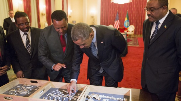 Ethiopian Prime Minister Hailemariam Desalegn watches as President Barack Obama touches'Lucy' part of several hundred pieces of bone representing 40 percent of a female Australopithecus afarensis who was estimated to have lived 3.2 million years ago