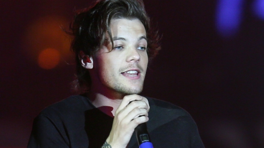 One Direction's Louis Tomlinson not impressed by baby doll thrown on stage