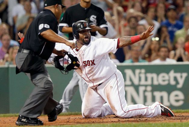 Boston Red Sox's Pablo Sandoval right gestures safe as home plate umpire Adrian Johnson makes the call after Sandoval was thrown out at home on a double by Ryan Hanigan during the third inning of a baseball game against the Chicago White Sox in Boston