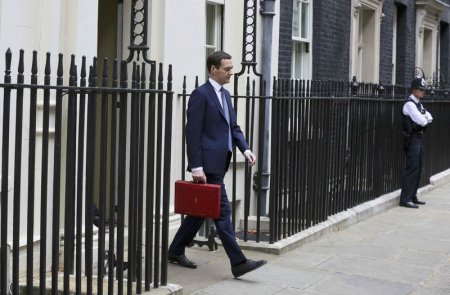 Britain's Chancellor of the Exchequer George Osborne walks out of number 11 Downing Street before delivering his budget to the Hoiuse of Commons in London Britain