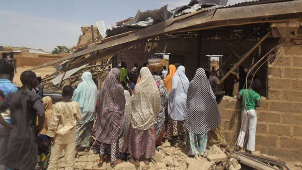 People gather around the Redeemed Christian Church of God after a bomb blast in Potiskum Nigeria