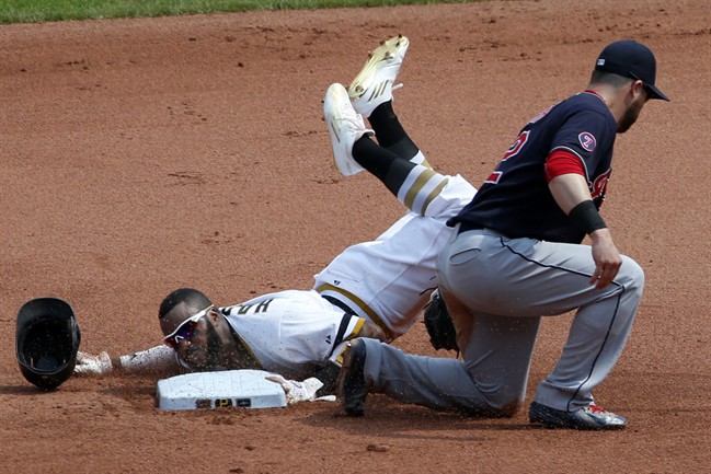 Pittsburgh Pirates Josh Harrison holds the second base bag as he steals second ahead of the tag by Cleveland Indians second baseman Jason Kipnis during the seventh inning of a baseball game in Pittsburgh Sunday