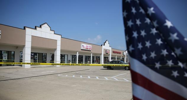 Members of the FBI Evidence Response Team investigate the shooting at the Armed Forces Career Center  National Guard Recruitment Office on July 17 in Chattanooga Tenn. Since the shooting armed civilians have begun trying to guard such centers