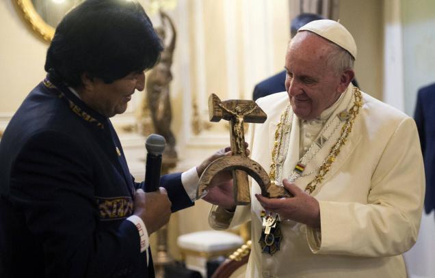 Pope Francis is presented with a gift of a crucifix carved into a wooden hammer and sickle the Communist symbol uniting labor and peasants by Bolivian President Evo Morales in La Paz Bolivia Wednesday