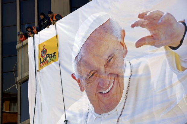 Pope Francis gives a thumbs up from the popemobile in Quito